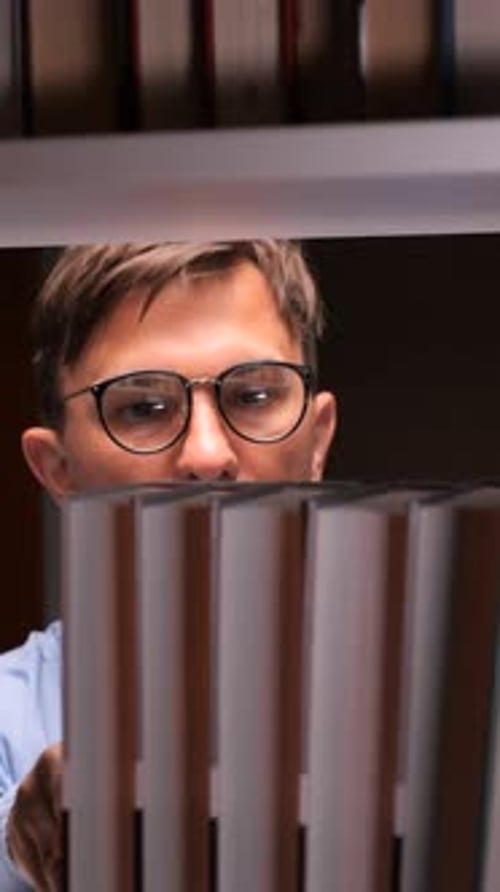 Vertical Video Student Searching for Book on Library Shelf