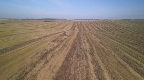 Tractor working on the field doing tillage with cultivator