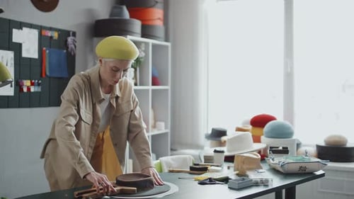 Stylish Woman Making a Hat in Her Studio