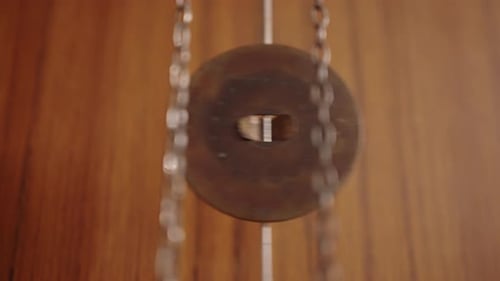 The Pendulum of an Old Clock is Swinging