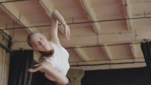 Young Woman Dancing in Open Studio Space