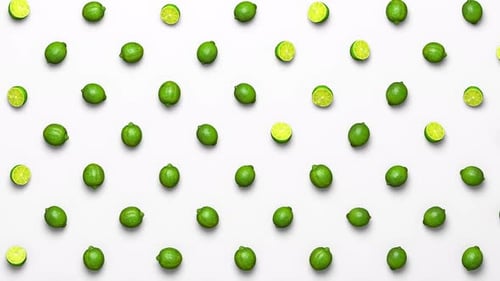 Seamless Loop of Falling Green Limes on White Background