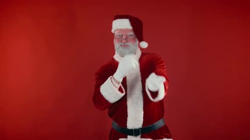 Funny Santa Claus Dances in Front of Red Backdrop