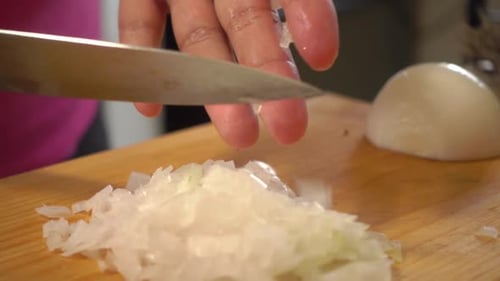 Dicing White Onion with Silver Kitchen Knife