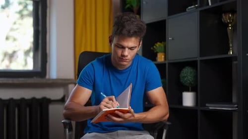 Man College Student Studying at Home Pov Sitting on Chair Listening Watching Lesson Online on