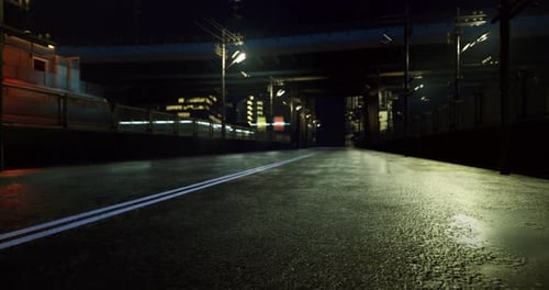 Nighttime Urban Road Under Bridge with Reflections and City Lights