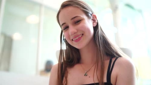 Young Woman Smiling Softly in a Bright Interior