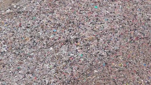 Aerial view of a vast landfill with garbage and plastic waste