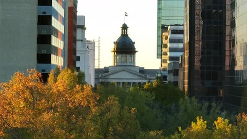 South Carolina State House aerial reveal. Long zoom shot between Columbia, SC skyscrapers.