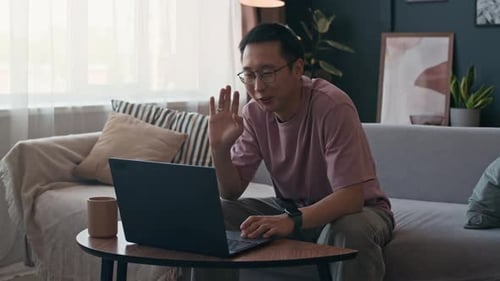 Entrepreneur Calling on Video Using Laptop in Home Office