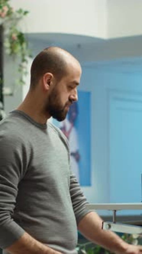 Vertical Video Mall Employee Assisting Customer to Choose From the New Collection of Clothes