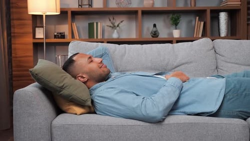 Happy Young Man Laying on Sofa Relaxed African American Guy Resting on Sofa