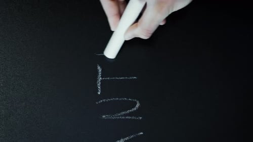 Hand Writes the Word Routine With Chalk