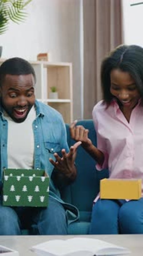Couple Opening Gifts and Celebrating at Home