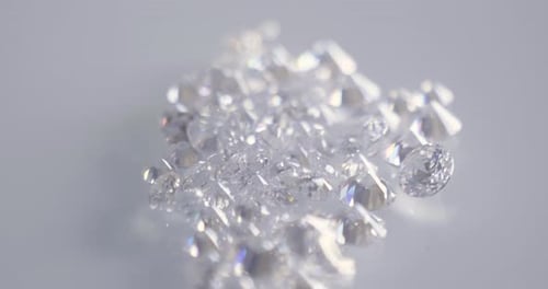 Close up of some white precious diamonds on a white bench. Concept: Gold, silver, jewelry