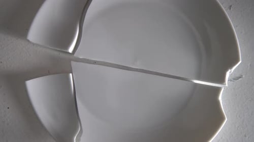 Layed Out Pile Of Broken White Plates Rotating The Camera Around