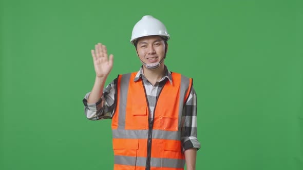 Asian Male Engineer Waving Hand Saying Bye While Standing In The Green ...