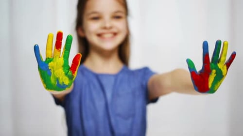 Smiling Girl Holding Out Painted Hands