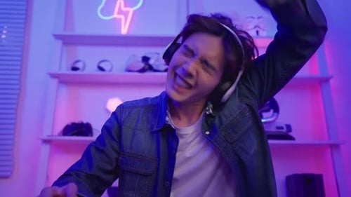 Excited Young Adult Playing a Video Game