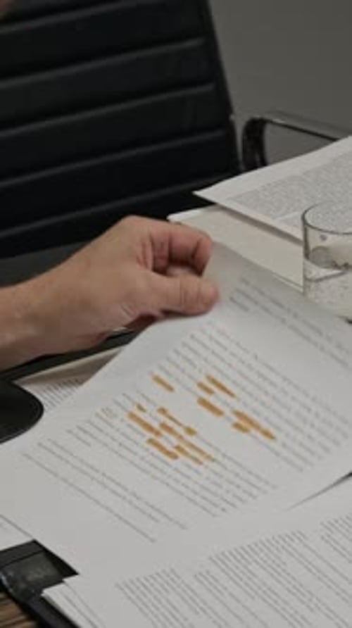 Man Reviews Legal Documents in Office Setting