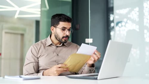 Man Receives Good News in Office, Expresses Joy
