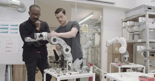 Engineers working on a robotic arm