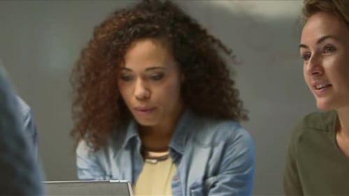 Coworkers Talking and Working Around a Table