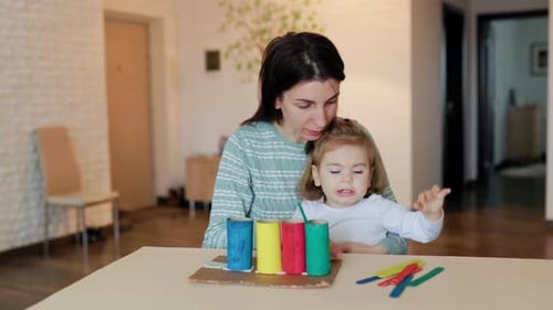 Mother and Child Learning with Colorful Toy