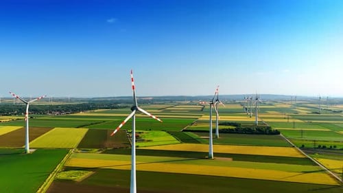 Numerous windmills in the beautiful countryside. Production of green energy. Aerial view.