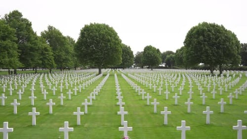 Wide (fake) drone shot of rows of white crosses at the Netherlands American Cemetery and Memorial in