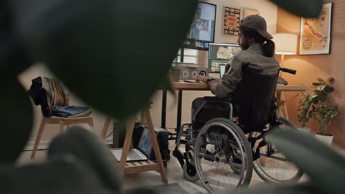 Adult Editing Video in Home Office