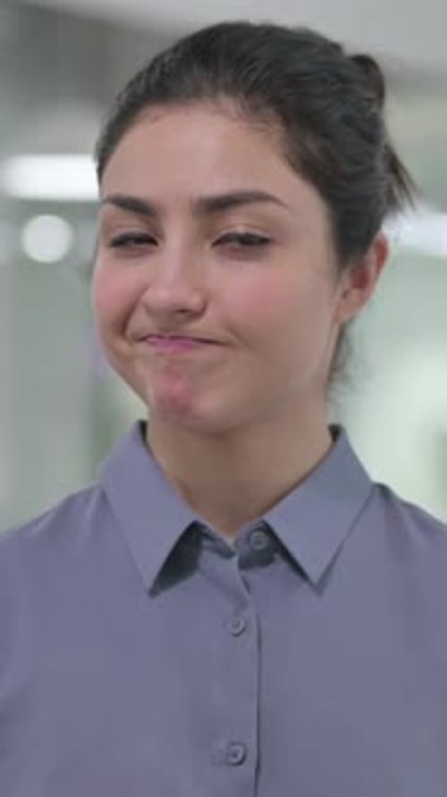 Young Adult Woman Smiling in a Workplace Setting
