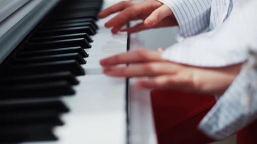 Close Up of Hands Playing the Piano