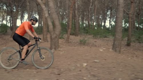 Epic Cinematic Video of a Male Mountain Bike Racer Speeding Through a Forest