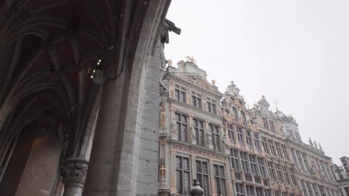 Snow Falling At The Guild Houses At Brussels Grand Place In Belgium During Winter. low angle shot