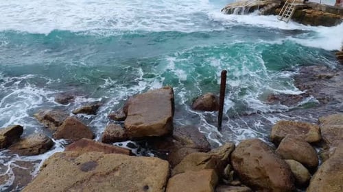 Waves Crashing on Rocks by the Ocean