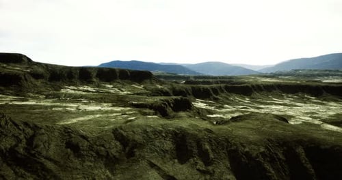 Dramatic Rocky Landscape Showcases Natural Textures and Distant Mountains