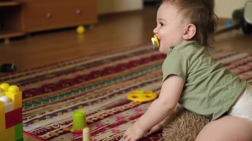 Cute Infant Playing with Toys on Carpet