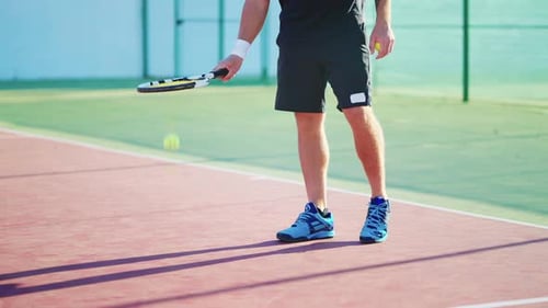 Legs of Tennis Player on Court in Summer