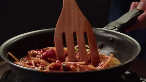 Spaghetti Being Stirred with Wooden Spatula