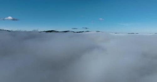 Drone Flight Over the Clouds During Sunrise