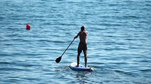 Man Sup Sea Strong Athletic Man Learns to Paddle Sup Standing on Board in Open Sea Ocean on Sunny