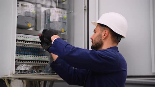 Electrician Fixing Electrical Panel Wiring Outdoors