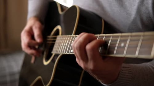 Playing the Guitar Strumming Black Acoustic Guitar Musician Plays Music Man Fingers Holding Mediator