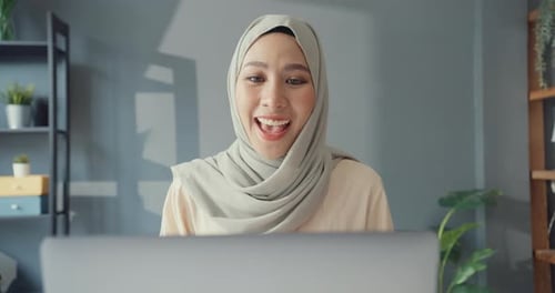 Woman Uses Laptop for Video Call at Home