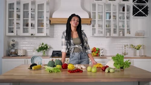 Smiling Woman with Produce in Modern Kitchen