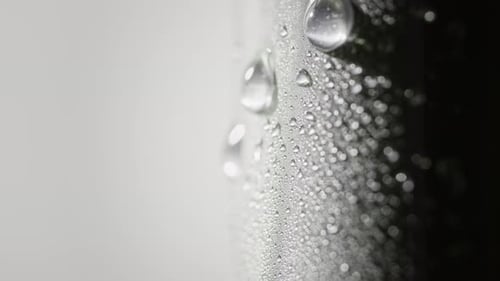 Gouttelettes d'eau scintillantes sur une surface métallique avec condensation