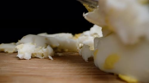 Hard Boiled Egg Being Chopped with Fork