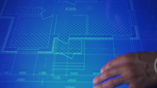 A Human Hand with a Watch Moves the Blueprint on an Interactive Monitor