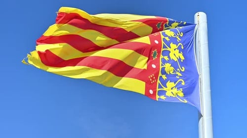 Colorful Flag Waving Against Blue Sky